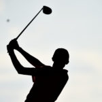 golfer tees off